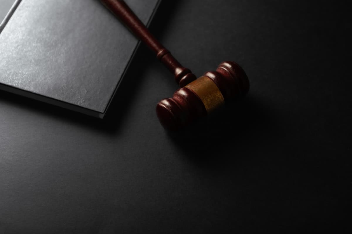 Gavel resting beside a law book, representing regulatory compliance