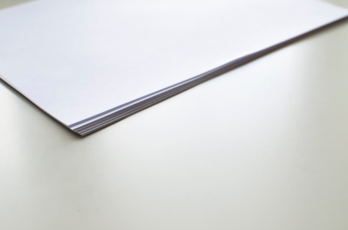 Stack of documents on a desk, representing preparation of possession memos and statutory records